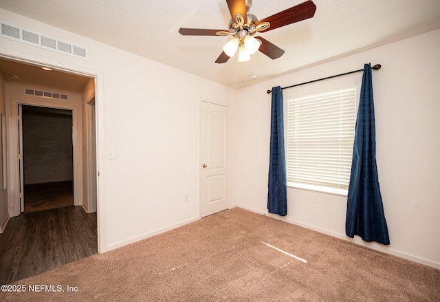 spare room featuring carpet flooring and ceiling fan