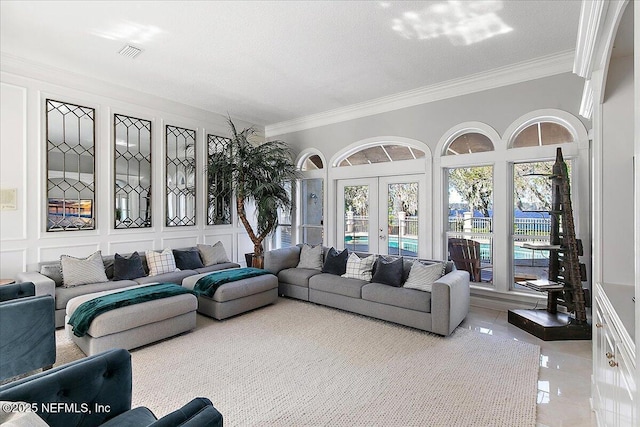 tiled living room with ornamental molding, a textured ceiling, and french doors