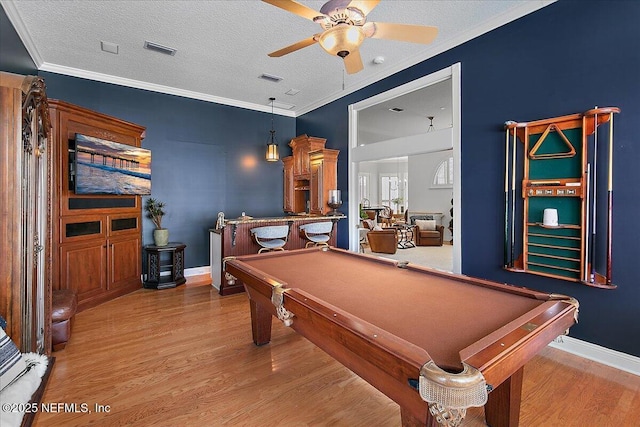 recreation room featuring crown molding, light hardwood / wood-style flooring, a textured ceiling, and billiards