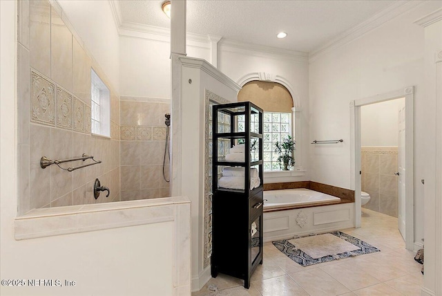 bathroom featuring tile patterned floors, ornamental molding, tile walls, independent shower and bath, and toilet