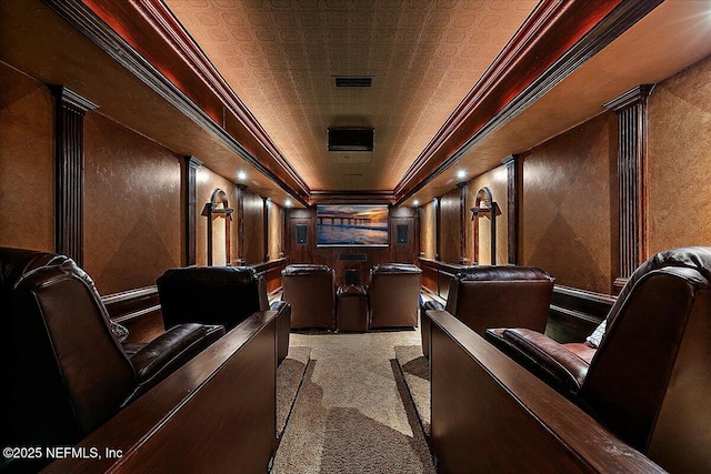 home theater room featuring light carpet, decorative columns, and crown molding