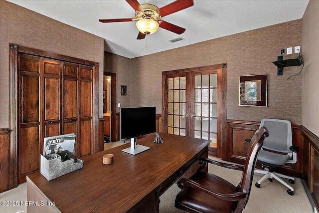 office area featuring a textured ceiling, ceiling fan, light carpet, and french doors