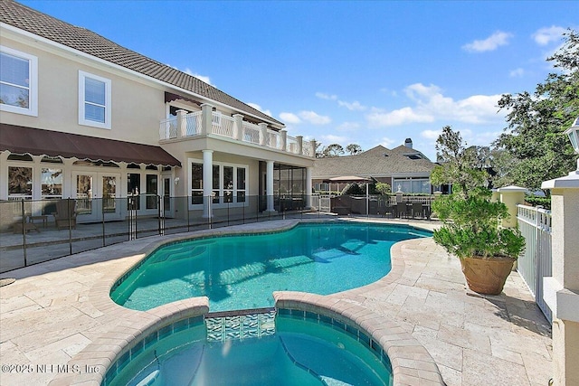 view of pool featuring an in ground hot tub and a patio