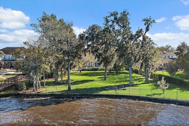 view of property's community featuring a yard and a water view