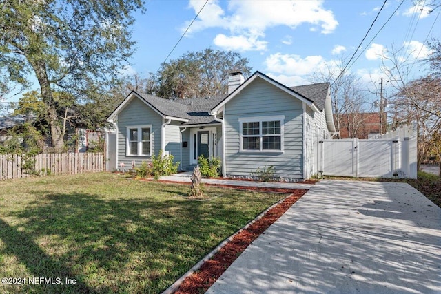 bungalow-style home with a front yard