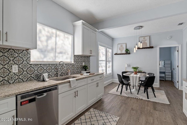 kitchen with sink, stainless steel dishwasher, dark hardwood / wood-style floors, decorative light fixtures, and white cabinets