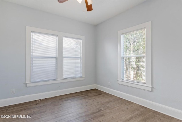 empty room with hardwood / wood-style flooring and ceiling fan