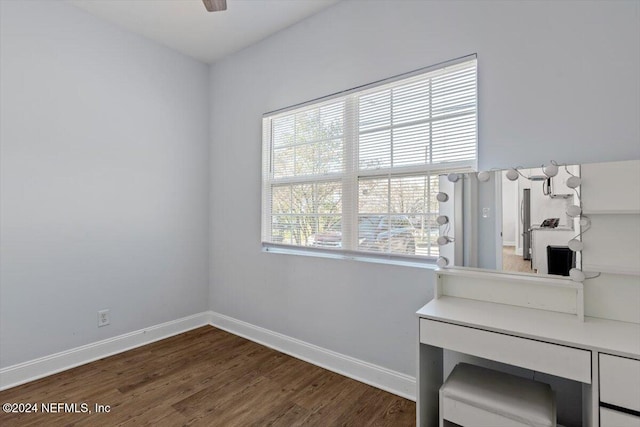 interior space with dark hardwood / wood-style floors, ceiling fan, and a healthy amount of sunlight