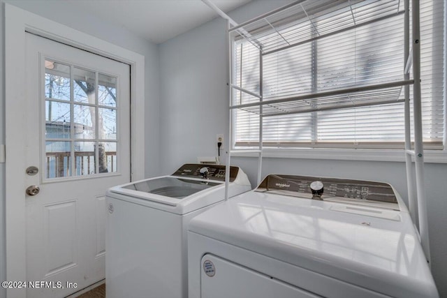 clothes washing area featuring separate washer and dryer