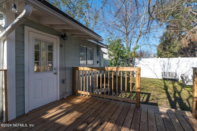 wooden deck featuring a yard