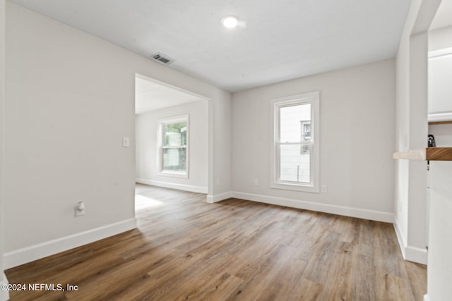 unfurnished living room featuring light hardwood / wood-style floors and a wealth of natural light