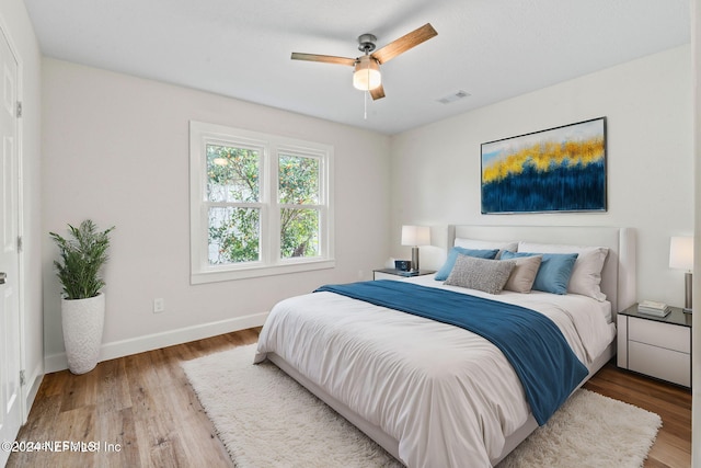 bedroom with hardwood / wood-style floors and ceiling fan