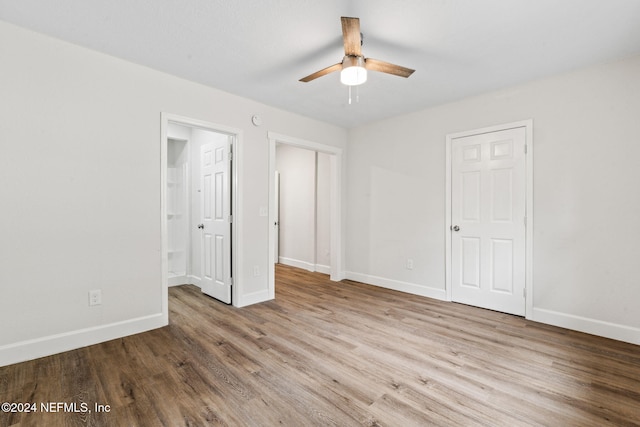 unfurnished bedroom with hardwood / wood-style floors and ceiling fan