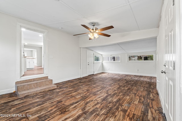 unfurnished living room with dark hardwood / wood-style floors, a healthy amount of sunlight, and ceiling fan