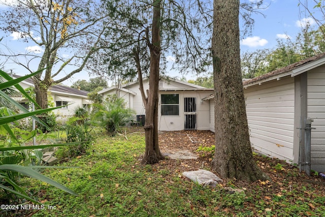 rear view of property featuring central AC