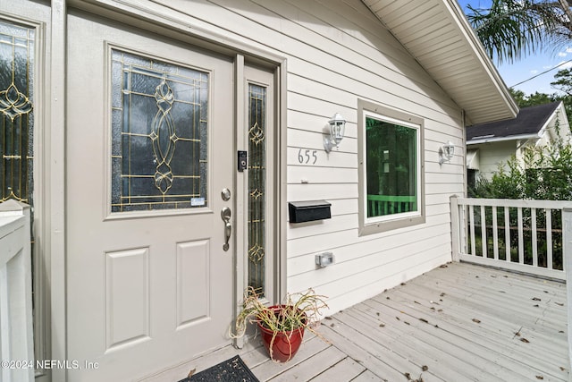 view of exterior entry featuring a deck