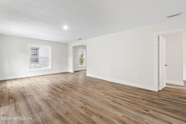 unfurnished room with hardwood / wood-style floors