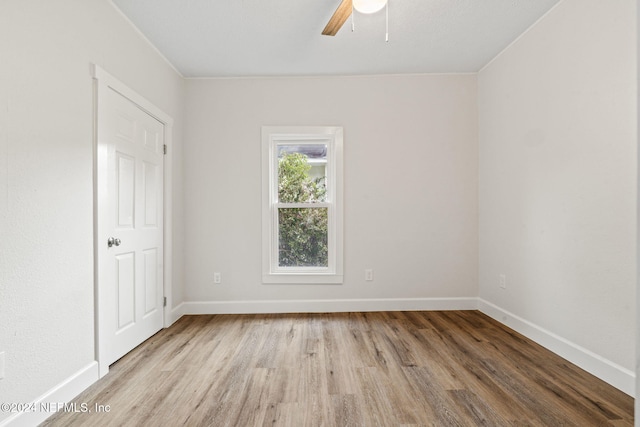 empty room featuring ceiling fan and light wood-type flooring