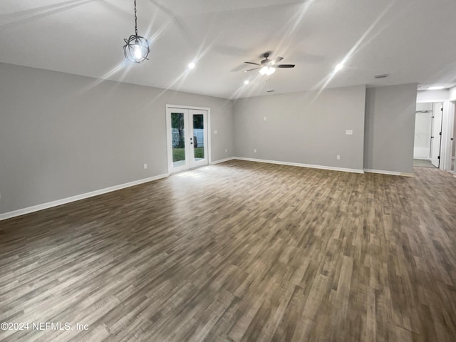 unfurnished living room featuring french doors, dark hardwood / wood-style flooring, ceiling fan, and lofted ceiling