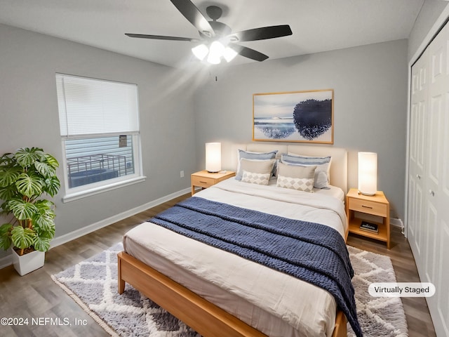 bedroom featuring dark hardwood / wood-style flooring, a closet, and ceiling fan