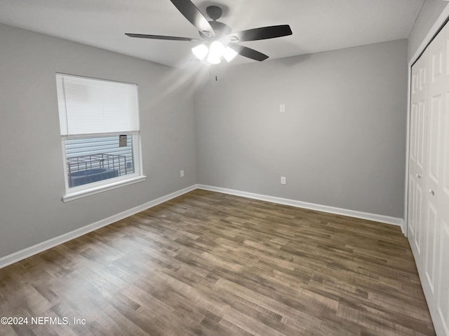 unfurnished bedroom with a closet, ceiling fan, and dark hardwood / wood-style floors