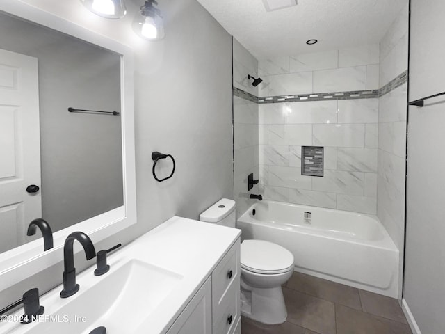 full bathroom featuring a textured ceiling, tiled shower / bath combo, vanity, tile patterned flooring, and toilet