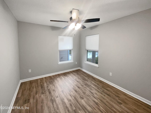 empty room with hardwood / wood-style flooring and ceiling fan