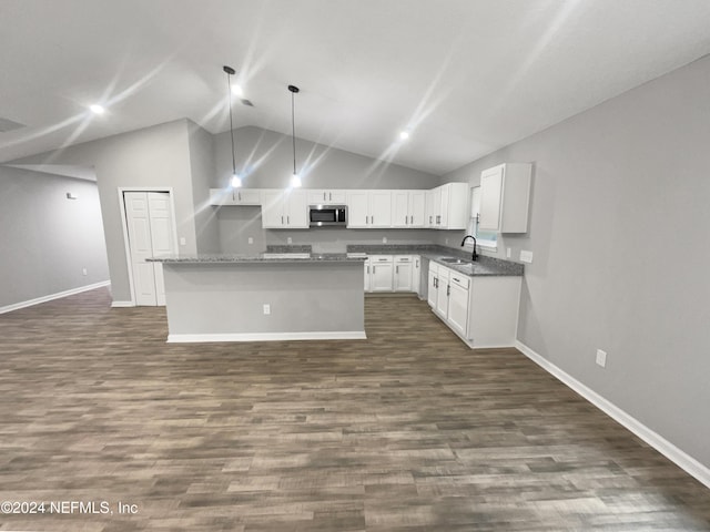 kitchen featuring pendant lighting, a center island, high vaulted ceiling, white cabinets, and sink