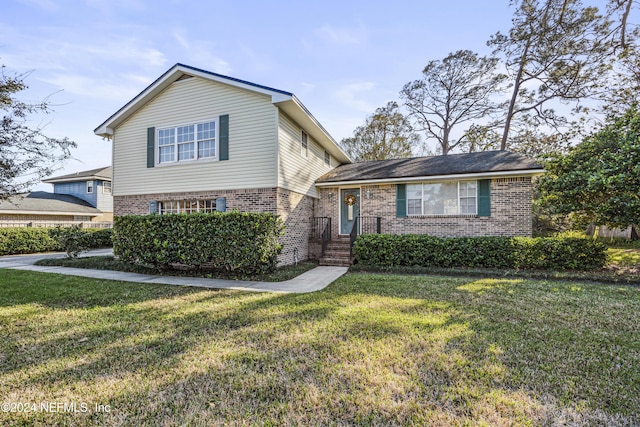 tri-level home with a front lawn