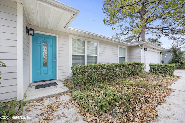 doorway to property featuring a garage