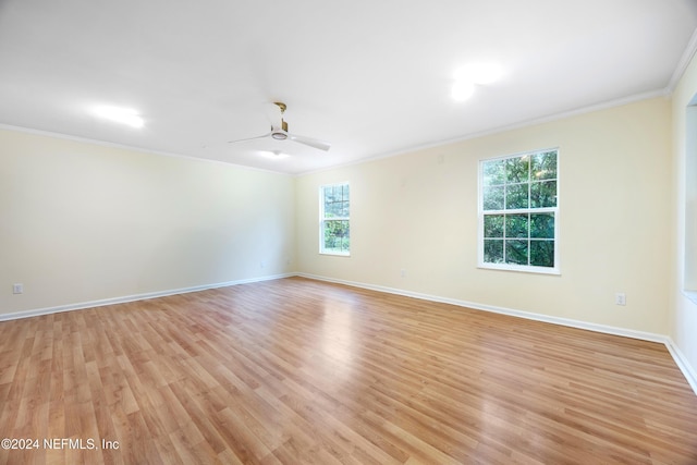 empty room featuring ceiling fan, light wood-type flooring, and ornamental molding