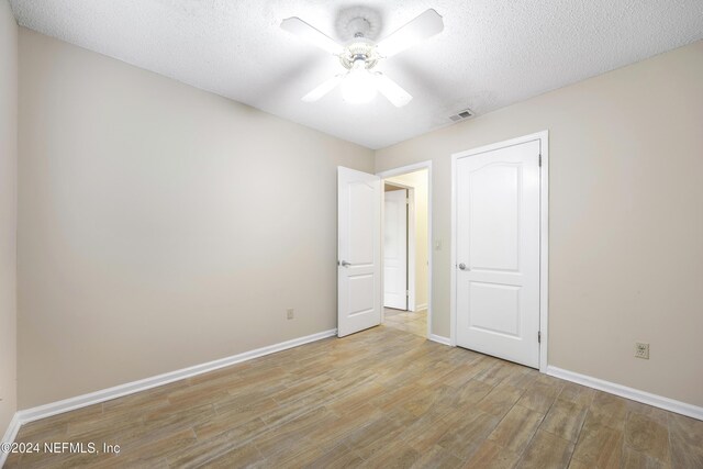 unfurnished bedroom featuring a textured ceiling and ceiling fan