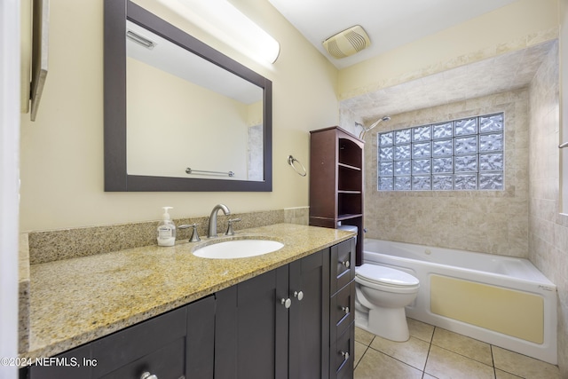 full bathroom featuring tile patterned flooring, vanity, toilet, and tiled shower / bath combo