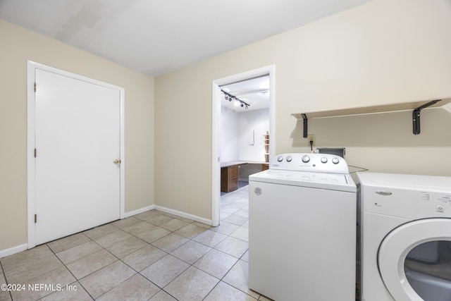 laundry room with light tile patterned flooring and washing machine and dryer