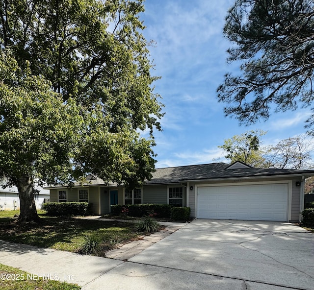 ranch-style home featuring a garage and driveway