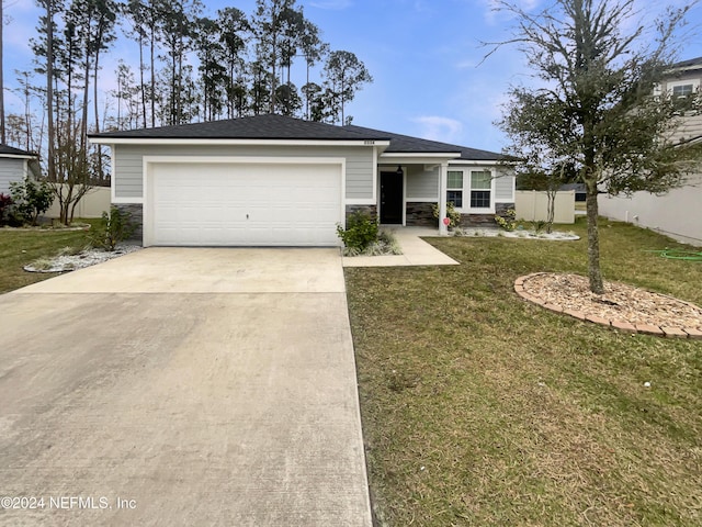 view of front of house featuring a front yard and a garage