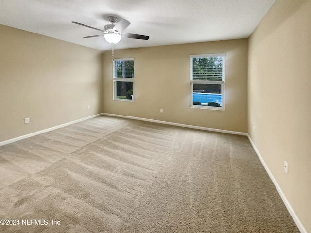 spare room with light carpet and ceiling fan