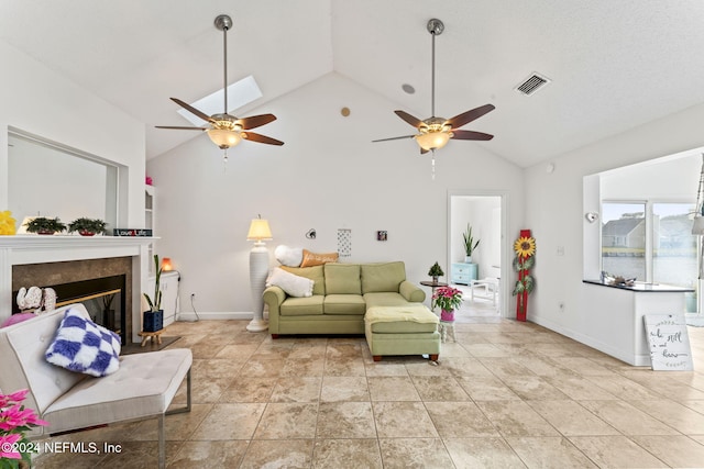 living room featuring vaulted ceiling, ceiling fan, and a premium fireplace