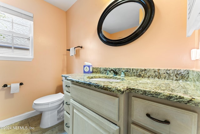 bathroom featuring tile patterned flooring, vanity, and toilet