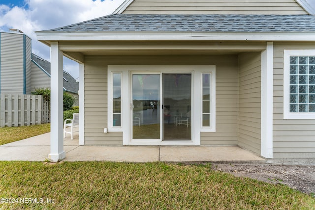 property entrance with a yard and a patio