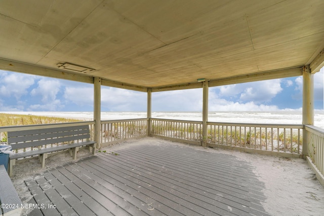 deck with a water view and a view of the beach