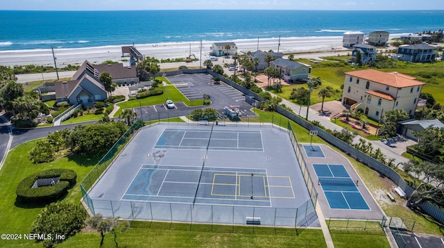 aerial view with a water view and a beach view