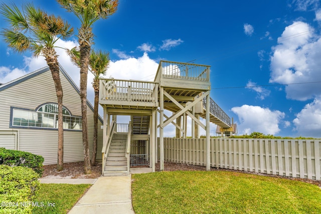 view of front property with a wooden deck and a front lawn