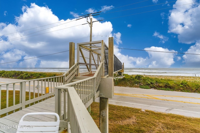 surrounding community featuring a water view and a view of the beach