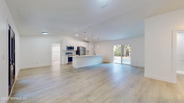 unfurnished living room with lofted ceiling, sink, and light hardwood / wood-style floors