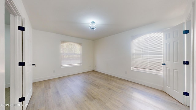 unfurnished room with light hardwood / wood-style flooring