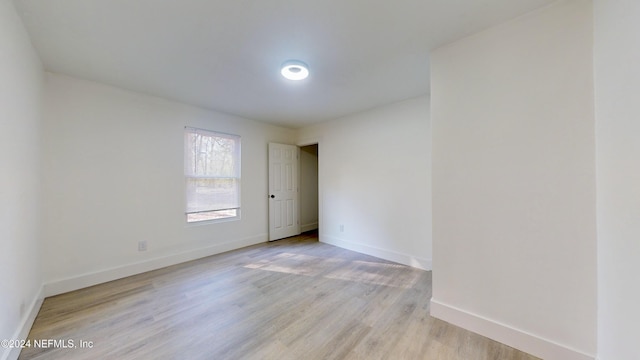 spare room featuring light hardwood / wood-style flooring