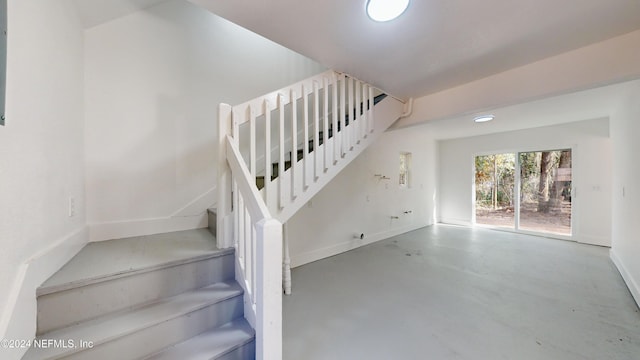 staircase featuring concrete flooring