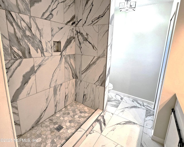 bathroom with toilet and tiled shower