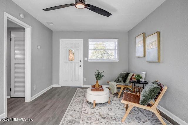 entrance foyer with ceiling fan and wood-type flooring